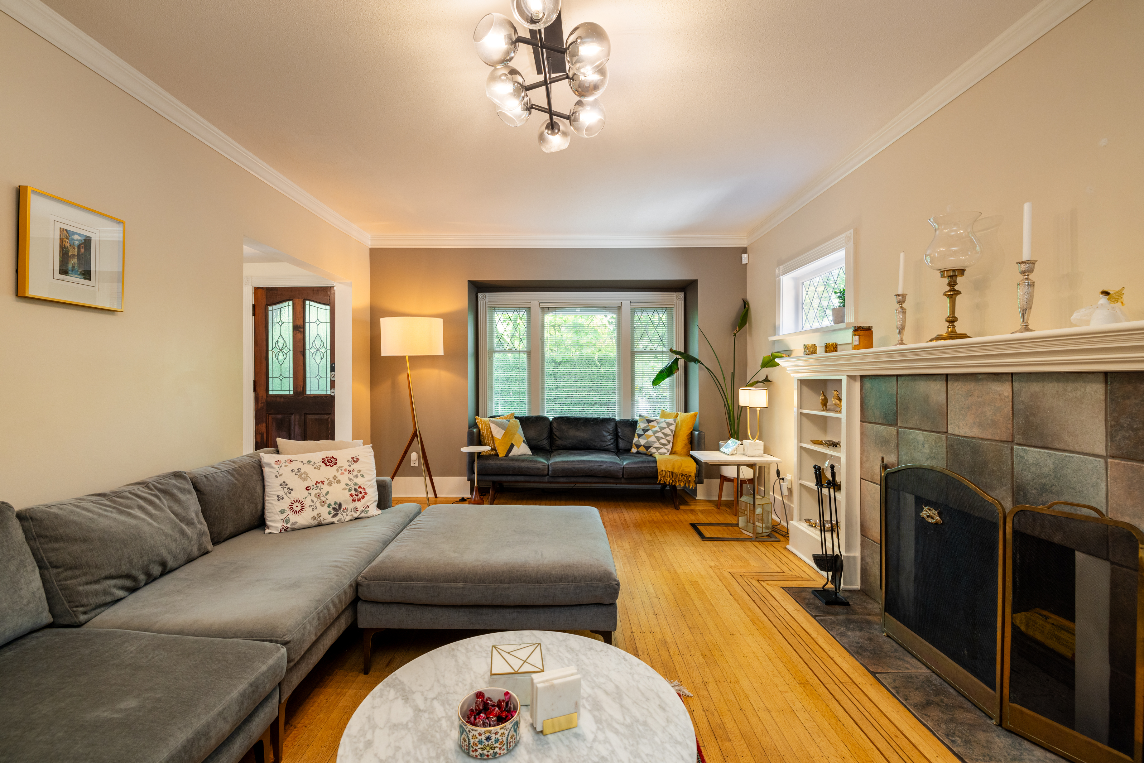 Living room with leaded bay windows, tiled fireplace and oak floors